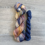 Load image into Gallery viewer, Skein of yarn in colourway Mystical Dreams with a co-ordinating  blue mini skein
