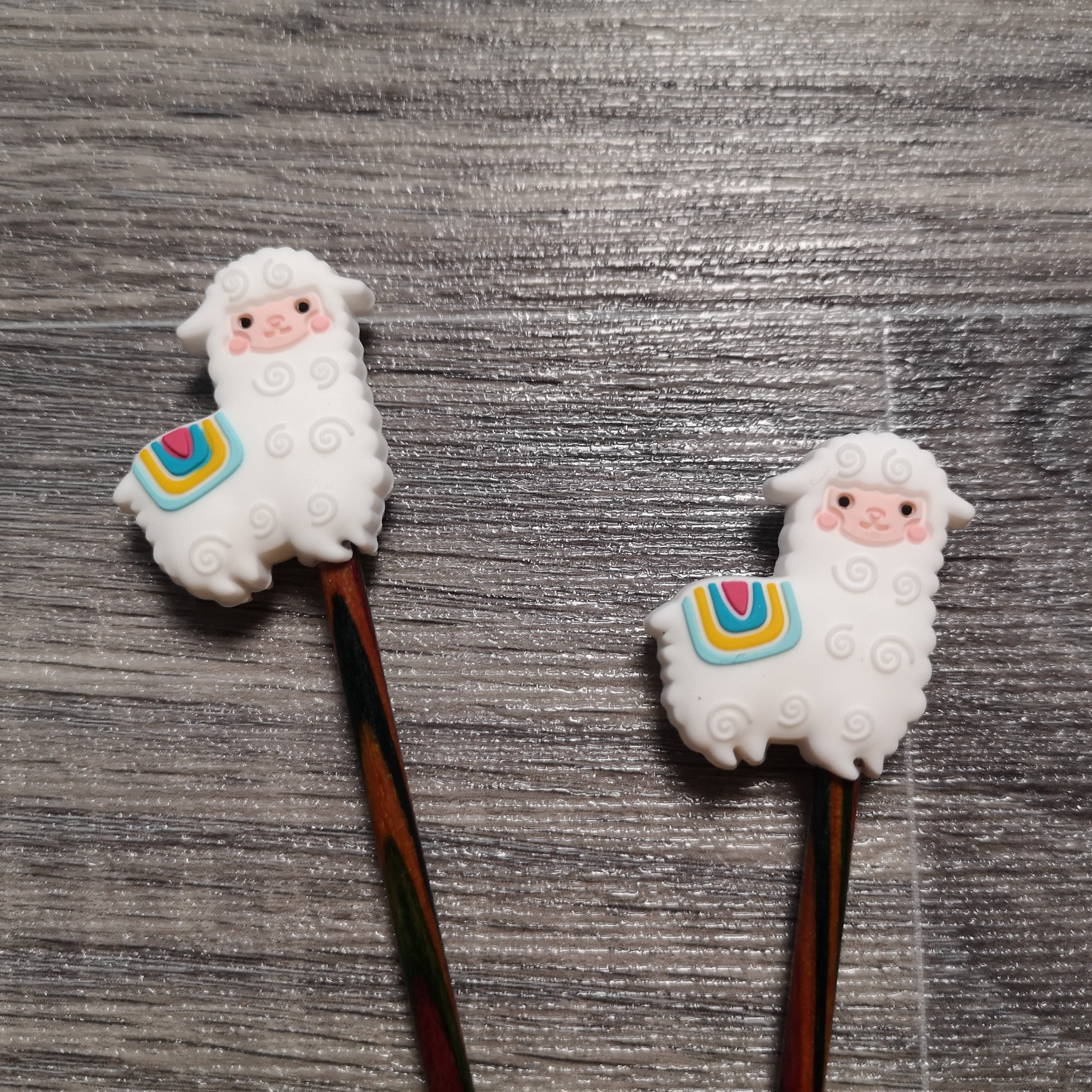 Close up of a set of white alpaca needle stoppers